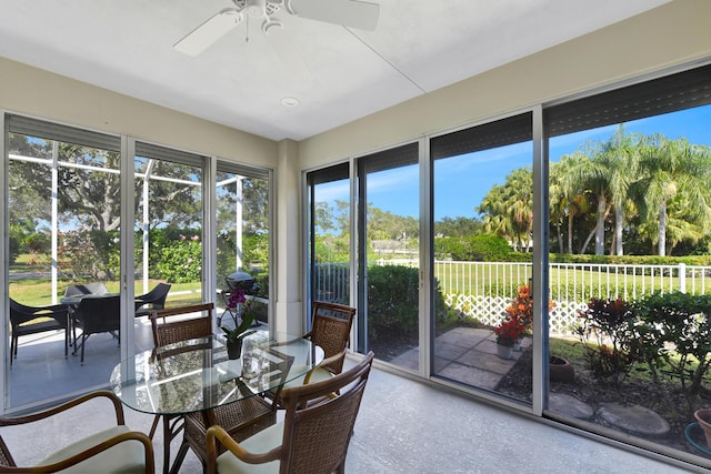 sunroom featuring ceiling fan