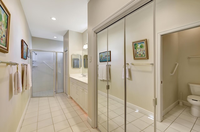 bathroom with tile patterned flooring, vanity, toilet, and an enclosed shower