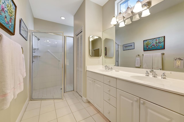 bathroom featuring tile patterned flooring, vanity, and a shower with shower door