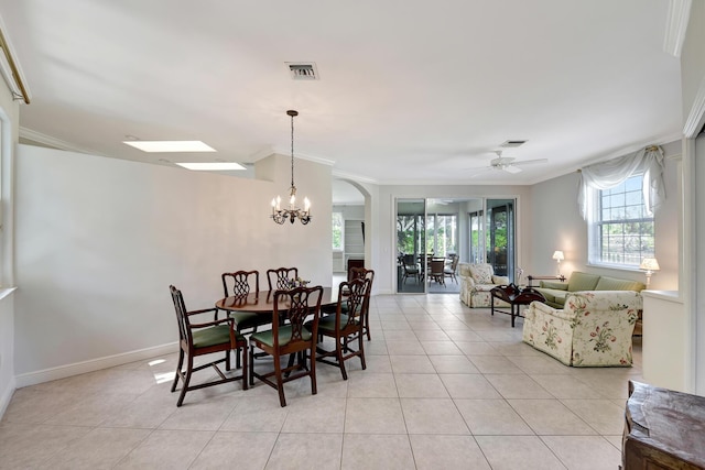 dining space featuring ceiling fan with notable chandelier, crown molding, and light tile patterned flooring