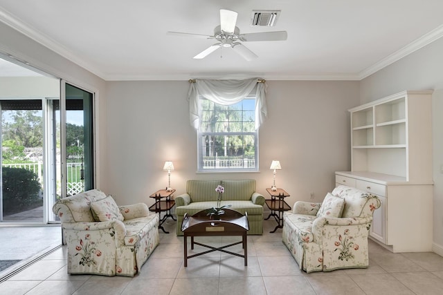 tiled living room featuring ceiling fan and ornamental molding