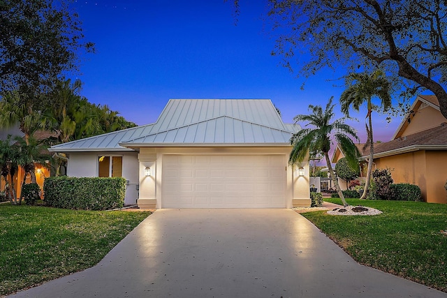 view of front of house featuring a yard and a garage