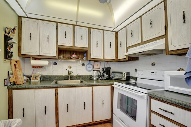 kitchen with backsplash, white appliances, sink, and light hardwood / wood-style flooring