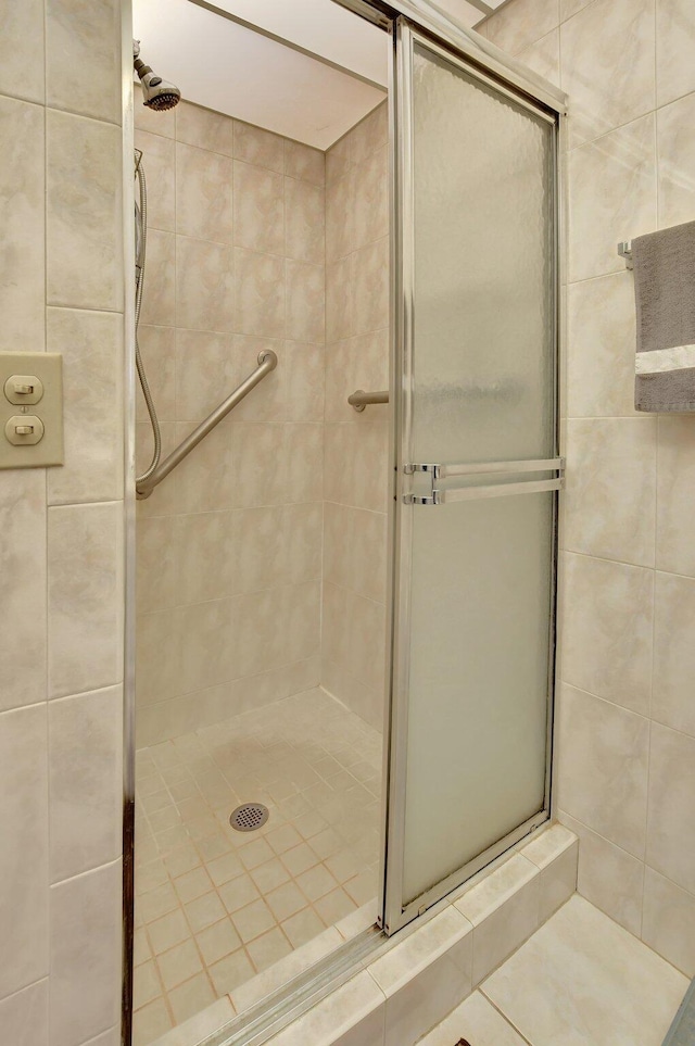 bathroom with a shower with door