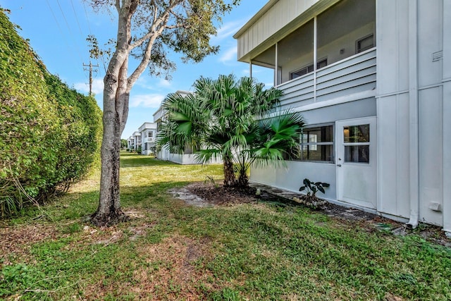 view of yard with a balcony