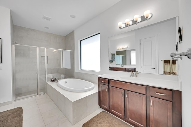 bathroom with tile patterned flooring, shower with separate bathtub, and vanity