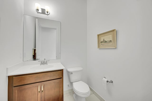 bathroom with tile patterned flooring, vanity, and toilet