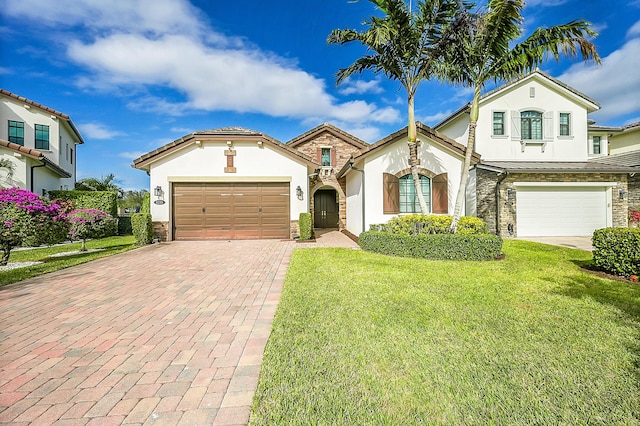 view of front of home featuring a front yard and a garage