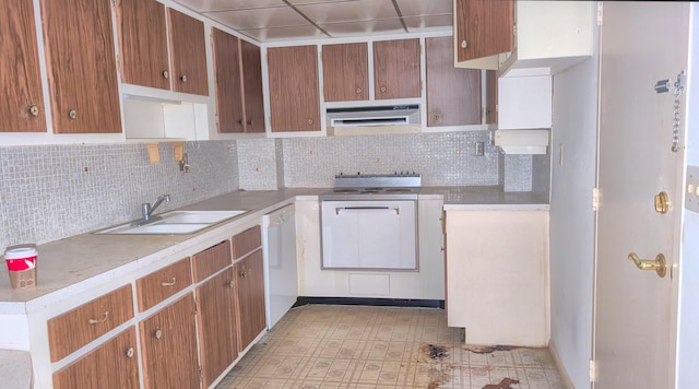 kitchen with dishwasher, decorative backsplash, extractor fan, and sink