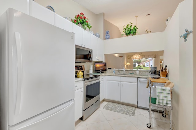 kitchen featuring high vaulted ceiling, white cabinets, sink, light tile patterned floors, and appliances with stainless steel finishes