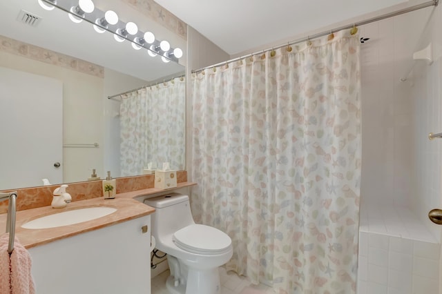 bathroom with tile patterned flooring, vanity, a shower with shower curtain, and toilet