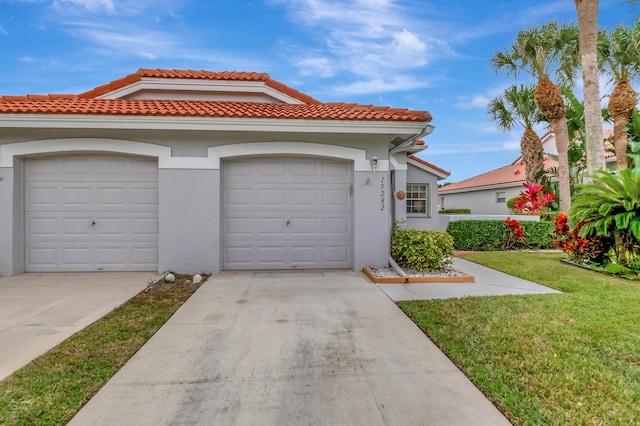 view of front of house with a garage and a front yard