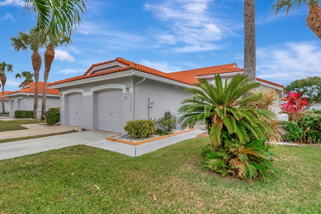 view of front of home with a garage and a front yard