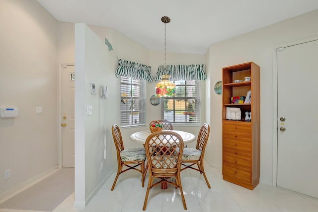 tiled dining room with a notable chandelier