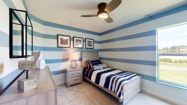 bedroom with ceiling fan and light carpet