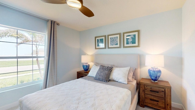 bedroom featuring multiple windows, carpet, and ceiling fan