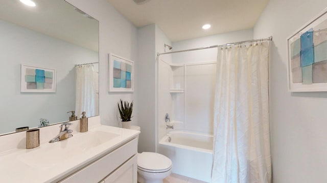 full bathroom with vanity, shower / bath combo, and toilet