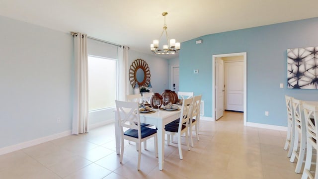 dining area with a notable chandelier and light tile patterned flooring