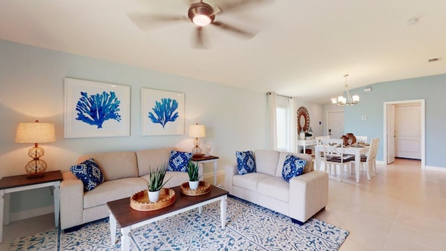 living room featuring ceiling fan with notable chandelier and vaulted ceiling