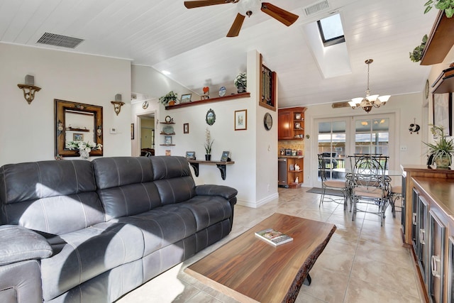 living room featuring ceiling fan with notable chandelier, lofted ceiling with skylight, light tile patterned floors, and wooden ceiling