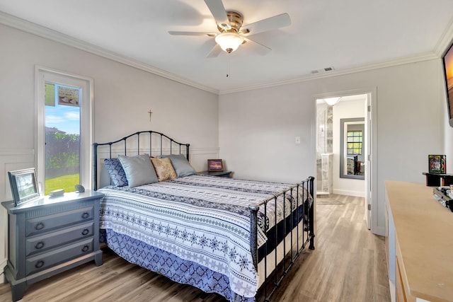 bedroom featuring light hardwood / wood-style flooring, ceiling fan, and ornamental molding