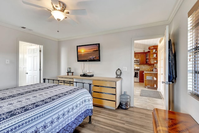 bedroom featuring ceiling fan, light wood-type flooring, and crown molding