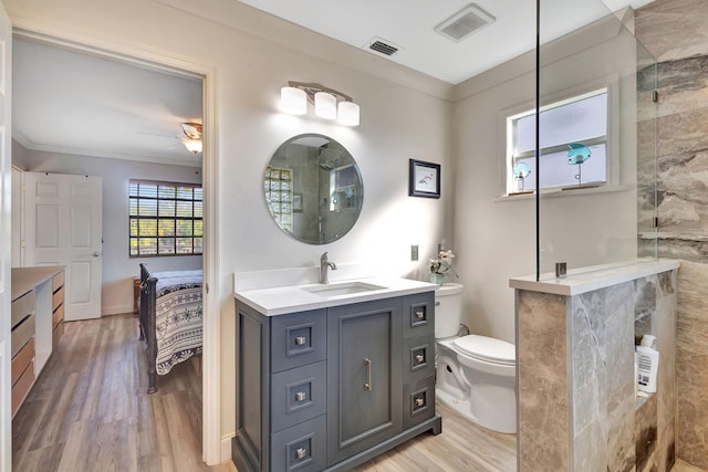 bathroom featuring hardwood / wood-style floors, vanity, toilet, and ceiling fan