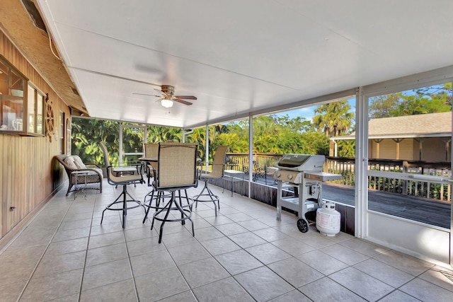 sunroom / solarium featuring ceiling fan and a healthy amount of sunlight