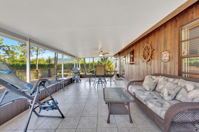 sunroom featuring ceiling fan and a healthy amount of sunlight