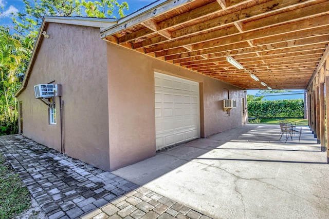 garage featuring a wall mounted air conditioner