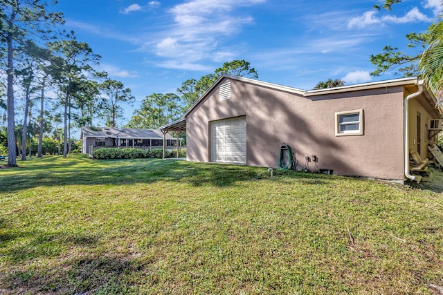 exterior space featuring a lawn and a garage