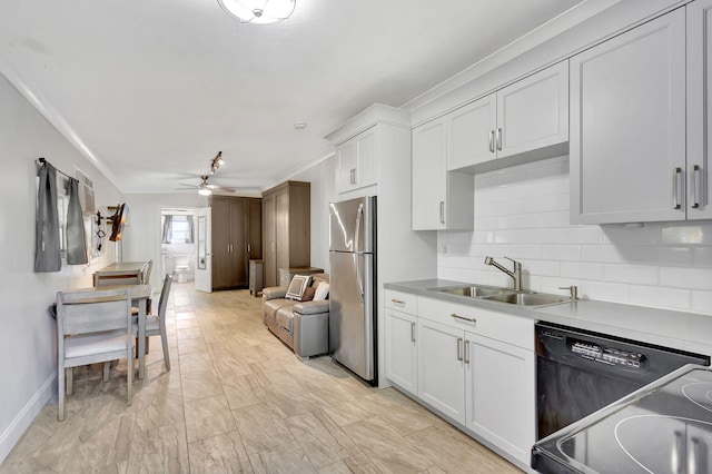 kitchen with white cabinetry, sink, dishwasher, tasteful backsplash, and stainless steel fridge