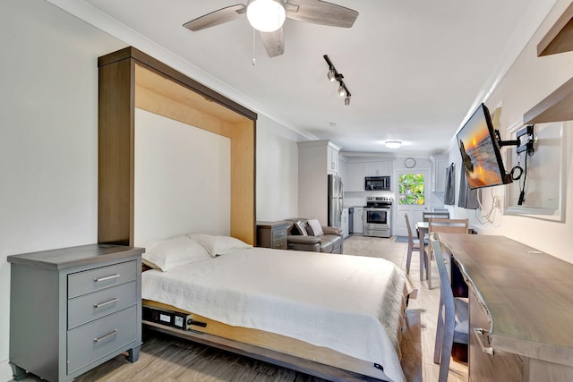 bedroom with stainless steel refrigerator, ceiling fan, light hardwood / wood-style floors, track lighting, and ornamental molding