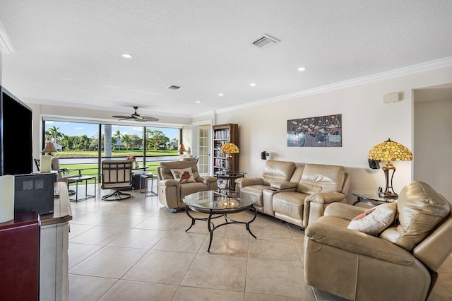 living room with light tile patterned floors, a textured ceiling, ceiling fan, and crown molding