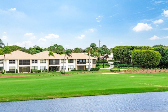 view of property's community with a water view and a yard