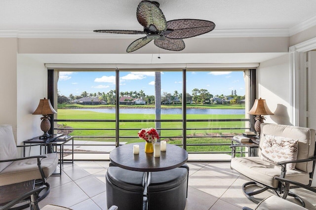 sunroom / solarium with ceiling fan and a water view