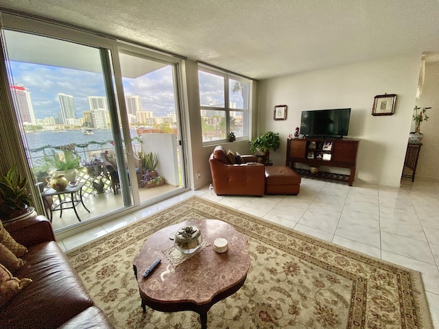 living room featuring light tile patterned flooring and a textured ceiling