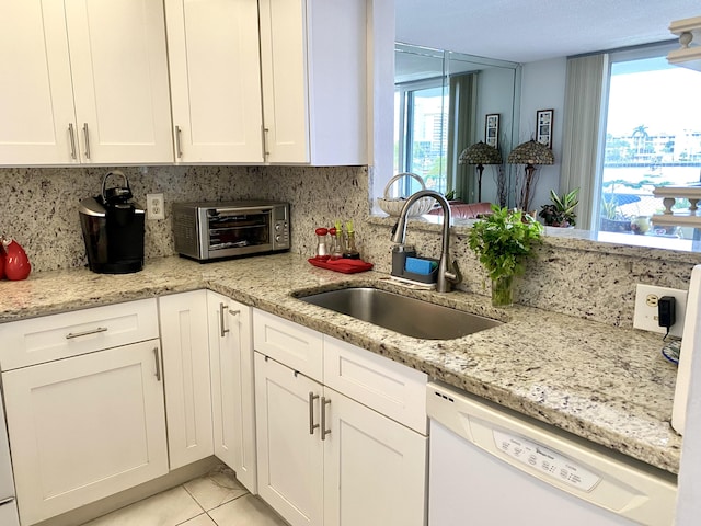 kitchen with dishwasher, white cabinets, a healthy amount of sunlight, and sink