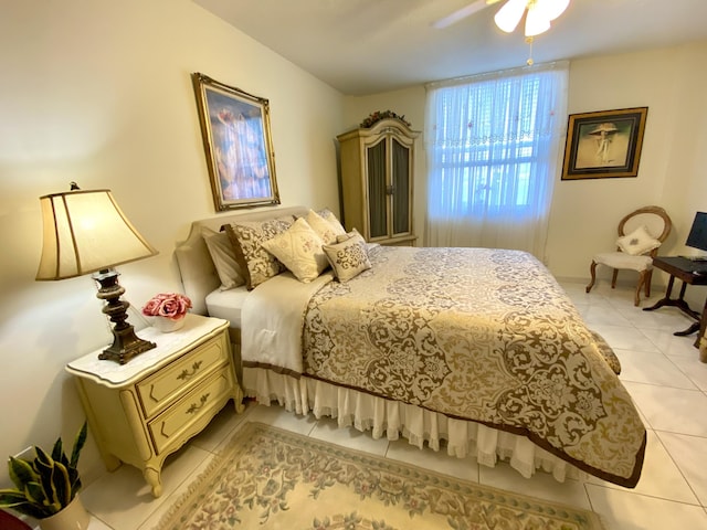 bedroom with ceiling fan and light tile patterned floors