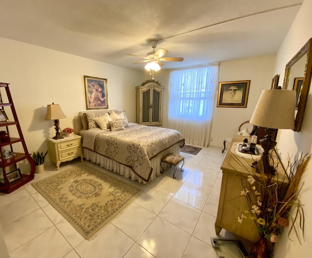 tiled bedroom with a textured ceiling and ceiling fan