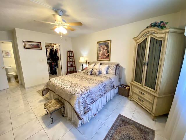 bedroom with ensuite bath, a spacious closet, ceiling fan, a closet, and light tile patterned floors