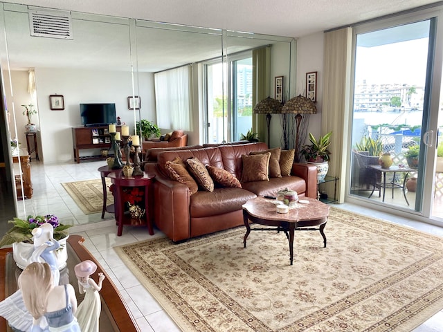 tiled living room featuring expansive windows and a textured ceiling