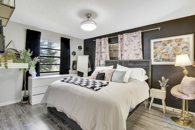 bedroom featuring a textured ceiling and hardwood / wood-style flooring