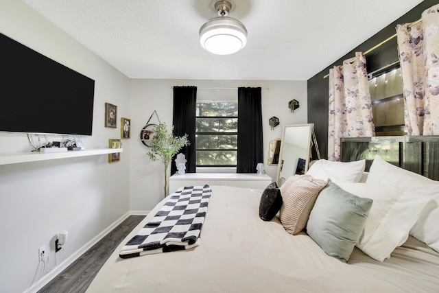 bedroom with dark wood-type flooring