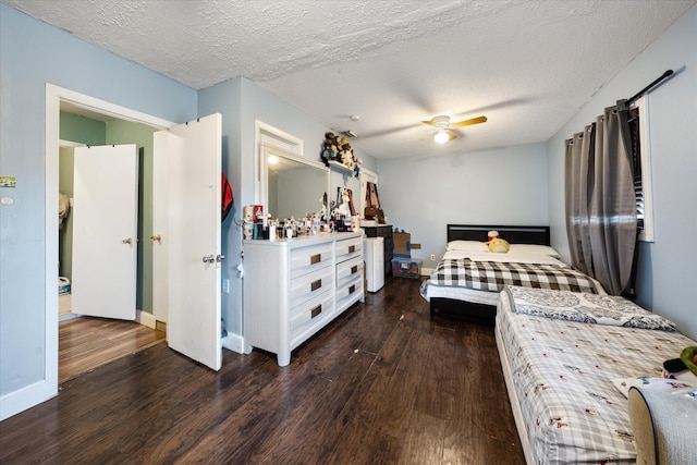 bedroom featuring ceiling fan, dark wood-type flooring, and a textured ceiling