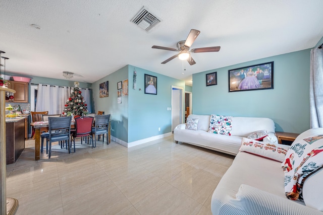 living room featuring a textured ceiling and ceiling fan