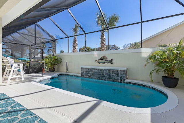 view of swimming pool featuring glass enclosure and a patio