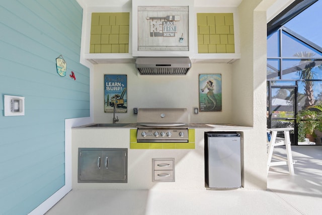 interior space with stainless steel fridge, wall chimney exhaust hood, and wood walls