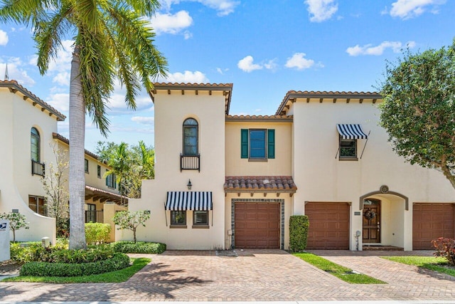 mediterranean / spanish home featuring a garage