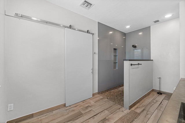 bathroom featuring hardwood / wood-style flooring and a textured ceiling